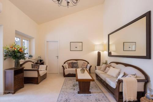 a living room with a couch and a table at New Luxury Villa Korcula Timeless with private pool, Free Parking, Seafront, for 6 persons in Korčula