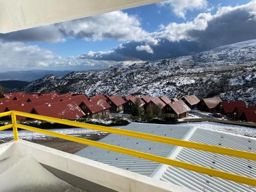 a view of a roof with snow covered roofs at EntreVales Serra da Estrela in Penhas da Saúde