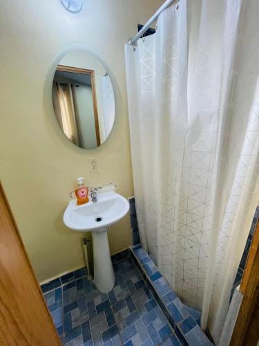 a bathroom with a sink and a mirror and a shower at Sunzal Bungalow Aloha in El Sunzal