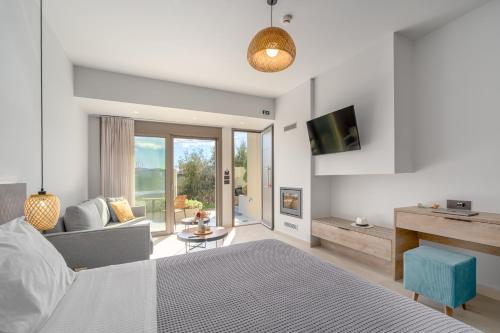 a bedroom with a bed and a living room at Harmony Apartments in Agioi Apostoli