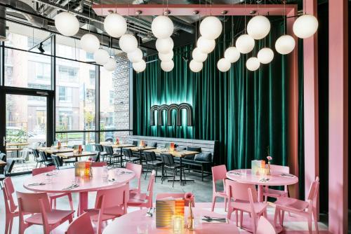 a restaurant with tables and chairs and a green curtain at The Social Hub Groningen in Groningen