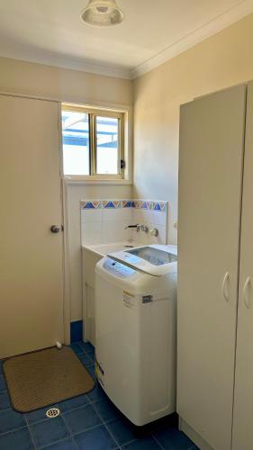 a small bathroom with a sink and a window at Catch N Relax in Point Turton