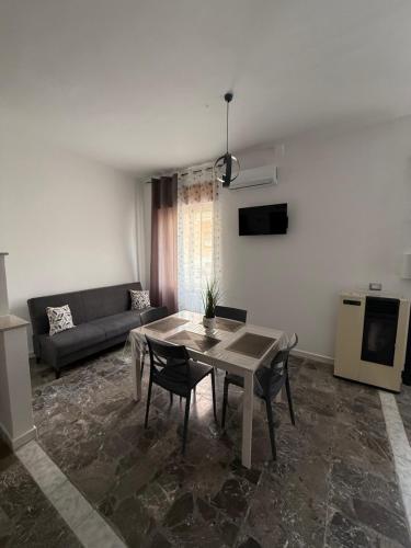 a living room with a table and a couch at Carmen House in Bernalda