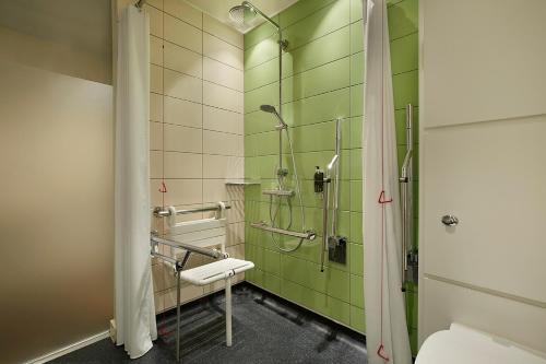 a bathroom with a shower and a toilet at hub London - King's Cross in London
