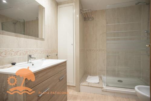 a bathroom with a sink and a shower at Holiday Apartment Patacona Beach in Valencia