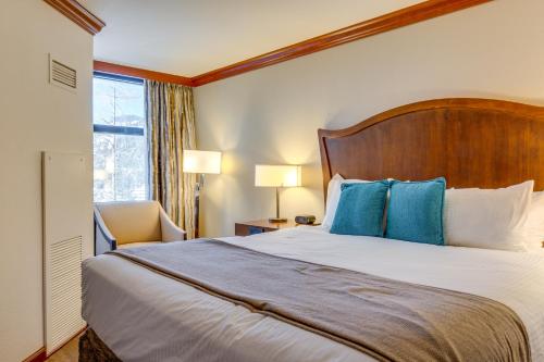 a hotel room with a large bed with blue pillows at Everline Resort Suite: North Lake Tahoe Luxury! in Olympic Valley