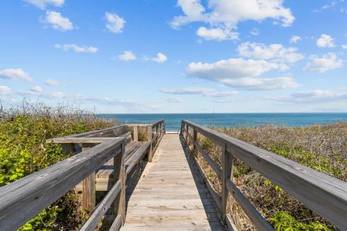 a wooden boardwalk leading to the beach at 2410 - Come Sail Away in Duck
