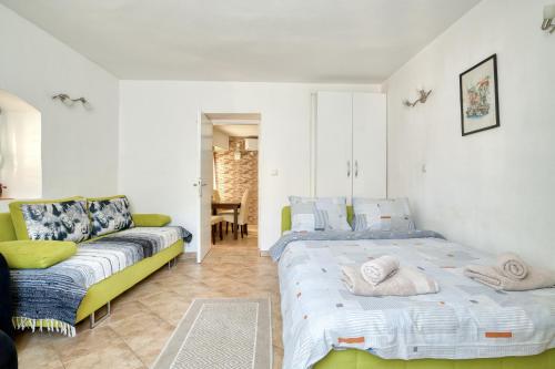 a bedroom with a bed and a couch at Old Town Boskovic Apartment in Kotor