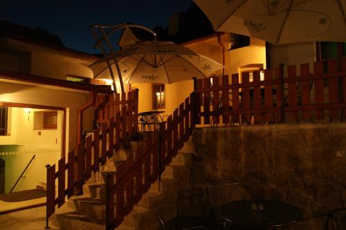 a set of stairs with umbrellas at night at Hotel Joseph 1699 in Třebíč