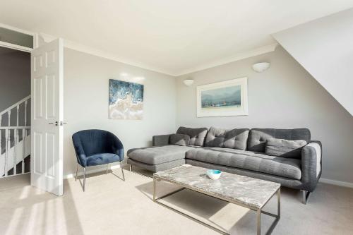a living room with a couch and a table at Reel Time - Beautiful Townhouse a Stone's Throw from Poole Quay in Poole