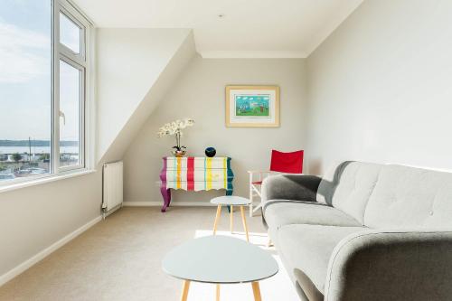 a living room with a couch and a table at Reel Time - Beautiful Townhouse a Stone's Throw from Poole Quay in Poole