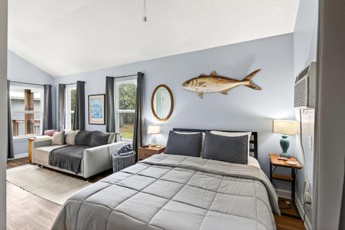 a bedroom with a bed and a fish on the wall at Gil's Bayou Cabins in Ocean Springs