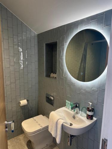 a bathroom with a sink and a toilet and a mirror at The Valentine - Townhouse Hotel - Adults Only in Edinburgh