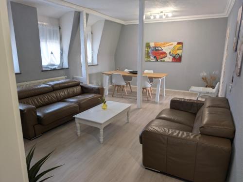 a living room with a couch and a table at Murgtalhouse Ferienwohnungen in Murg