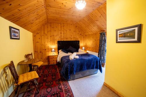 a bedroom with a bed in a wooden cabin at The Sheepshead Guesthouse in Durrus