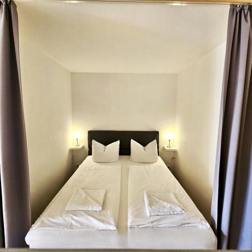 a bedroom with a large bed with two pillows at Ferienwohnung Panoramablick in Füssen