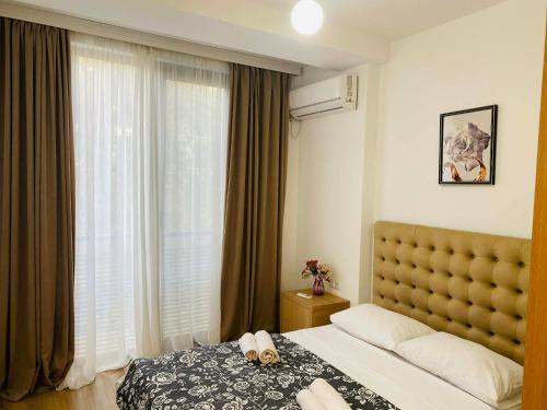a hotel room with a bed and a window at Holidays inkutaisi in Tsqnetʼi