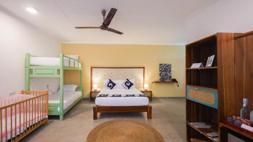 a bedroom with a bed and a bunk bed at Surfing Elephant in Matara