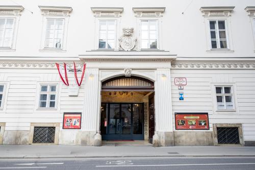 a white building with a doorway with a red ribbon at DATRI Petite Suite 4 in Vienna