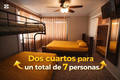 a bedroom with two bunk beds and a ceiling fan at Casa Bandera 54 in Guayabal