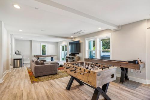 a living room with a foosball table and a couch at 4920 - Stress Less II in Kitty Hawk