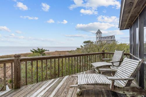 two chairs on a deck with a view of the ocean at 7828 - Swing Belly's Roost in Frisco