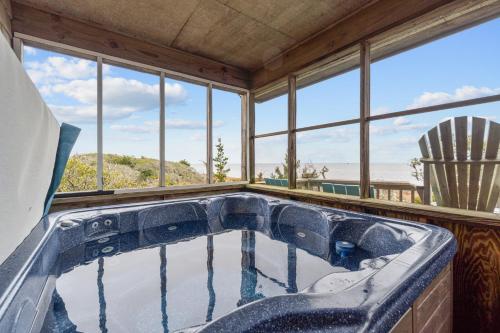 a jacuzzi tub in a room with windows at 7828 - Swing Belly's Roost in Frisco