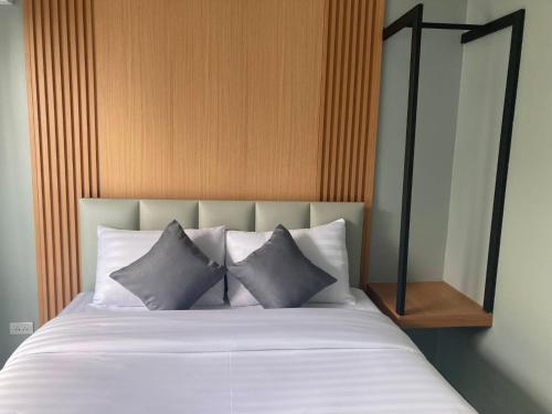 a bed with three pillows on top of it at Adira Residence in Ao Nang Beach