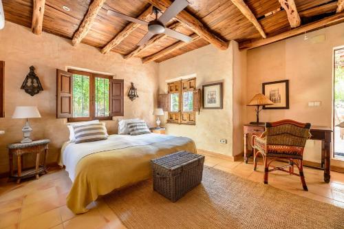 a bedroom with a bed and a table and chairs at Ca Na Ramona - Finca with Pool Santa Eularia in Santa Eularia des Riu