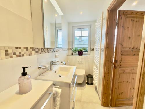 a bathroom with a sink and a mirror at Die 5 Ferienwohnungen der Familie Weber in Fehmarn