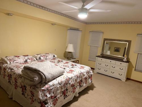 a bedroom with a bed and a dresser and a mirror at Prada Home Club in Punta Gorda