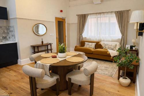 a living room with a table and chairs at The Old Borough Library - Staffordshire in Stafford