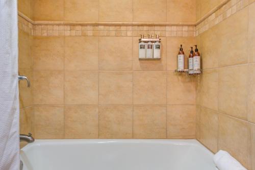 a bathroom with a shower with a white bath tub at Everline Resort Studio w/ Luxury Resort Perks in Olympic Valley
