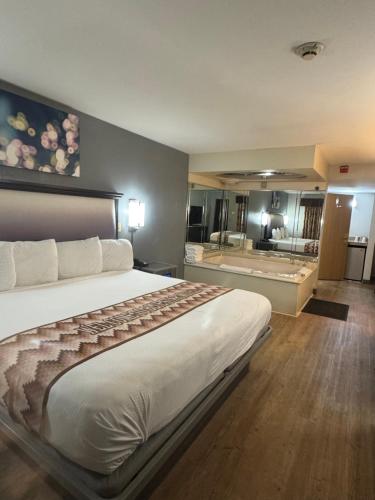 a hotel room with a large bed and a bathroom at Blue Star Motel in Chicago Ridge