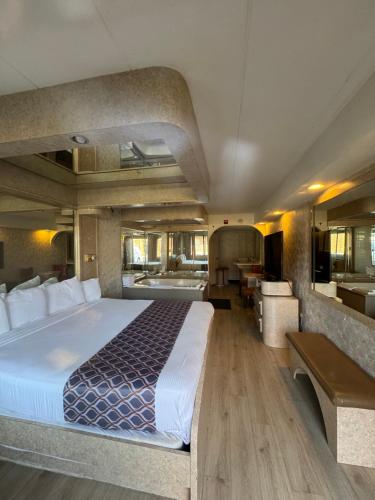 a large bedroom with a large bed and a bathroom at Blue Star Motel in Chicago Ridge