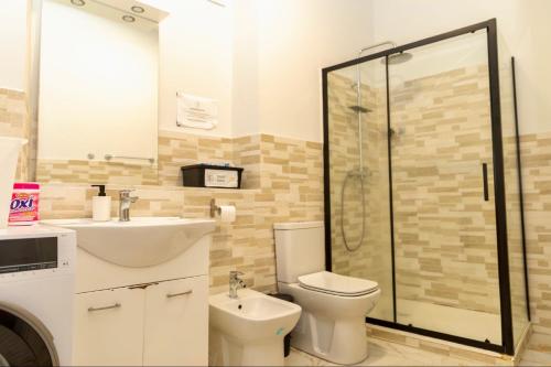 a bathroom with a sink and a toilet and a shower at Hostel Bosmi Bed&Language Liguria in Sori