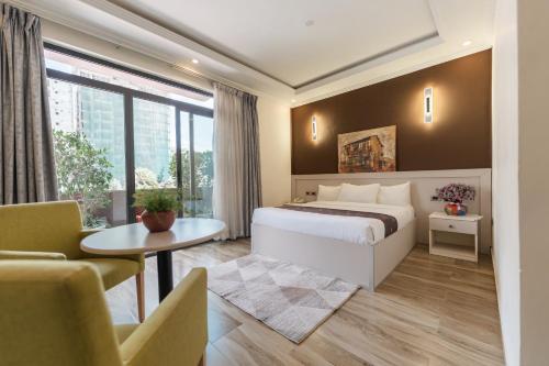 a bedroom with a bed and a table and a couch at Liyu Hotel Apartment in Addis Ababa