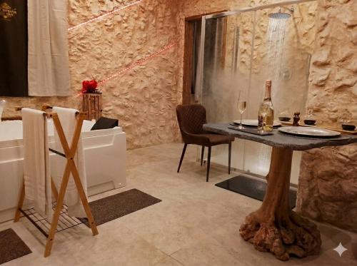 a bathroom with a table and a bottle of wine at suite pompei La Caverna in Pompei