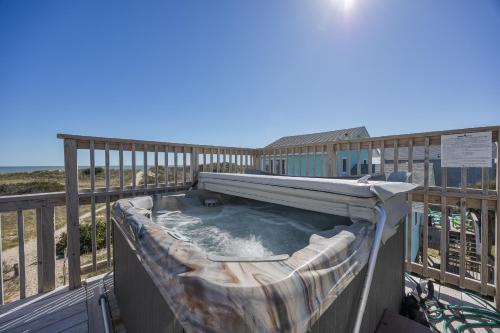 a hot tub on the deck of a beach house at 7158 - A Wave From It All in Waves
