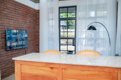 a kitchen with a counter and a window at Kilistone Apartments in Uru