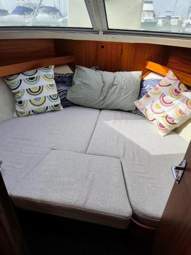 a bed in the middle of a boat with pillows at Jeddah in Izola