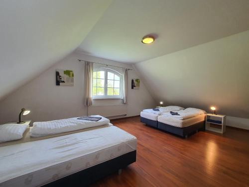 a room with two beds and a window at Villa Rezort Vlašky in Bešeňová