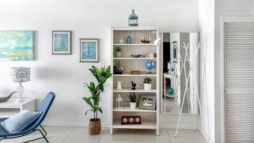 a room with a white shelf with plants and a chair at THE TIDES 2bedrooms apt 14th floor WE ARE ON THE BEACH! in Hollywood