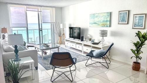 a living room with a couch and a tv at THE TIDES 2bedrooms apt 14th floor WE ARE ON THE BEACH! in Hollywood