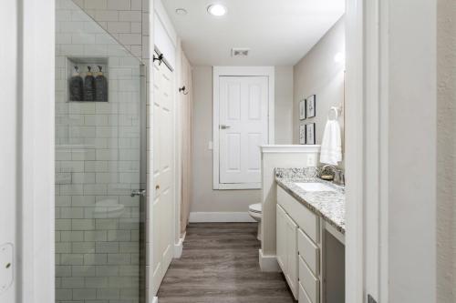 a bathroom with a shower and a sink and a toilet at Stunning Apartment w Panoramic Downtown Views! in McKinney
