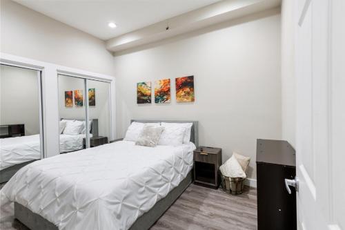 a bedroom with a bed with white sheets at Stunning Apartment w Panoramic Downtown Views! in McKinney