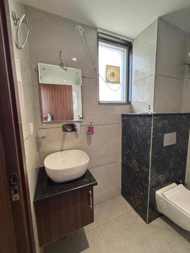 a bathroom with a sink and a mirror at Hotel The Balram in Ayodhya
