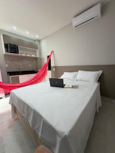 a bedroom with a bed with a laptop on it at Loft Brisas do Caeté in Bragança