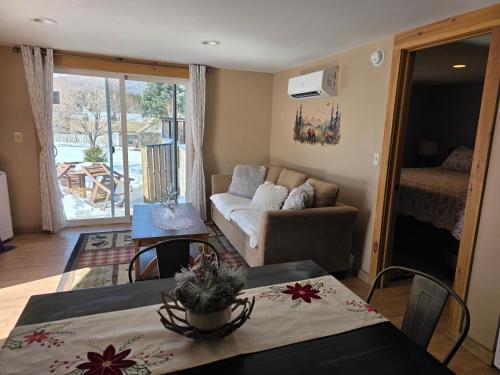 a living room with a table and a couch at Mountain View Cottage in Wilmington