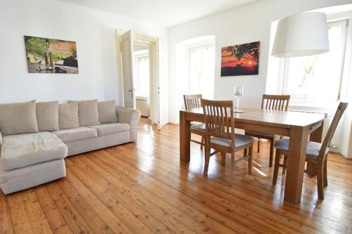 a living room with a table and a couch at Panorama in Aurisina